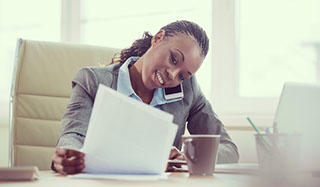 African woman sitting at desk talking on the phone